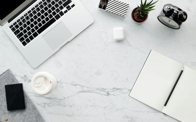 Neat office desk with coffee and laptop